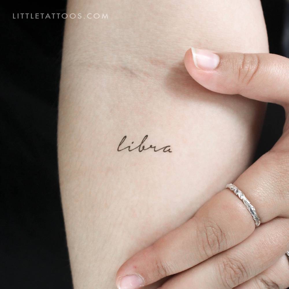Handwritten font "Libra" temporary lettering tattoo located on the inner forearm.