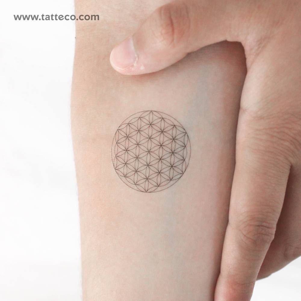 Fine line style flower of life temporary tattoo located on the inner forearm.