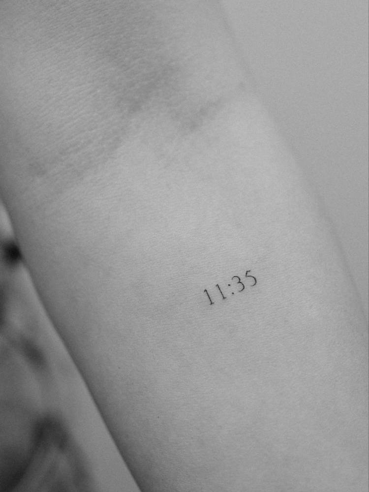 Hour tattoo located on the inner forearm, minimalistic style.