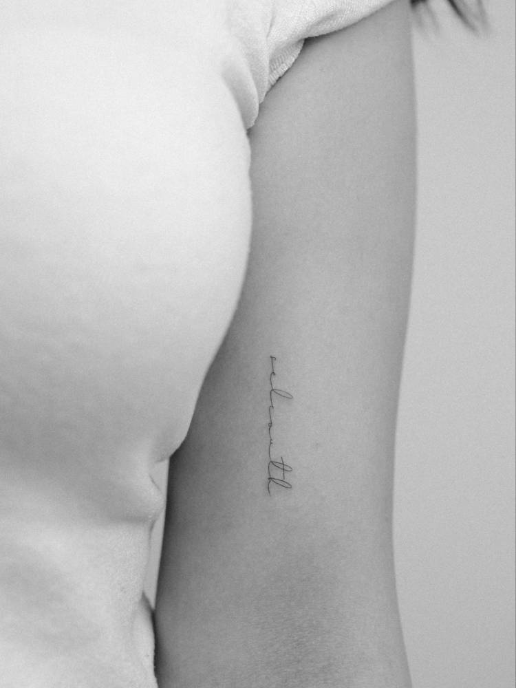 "Selcouth" handwritten lettering tattoo placed on the bicep.