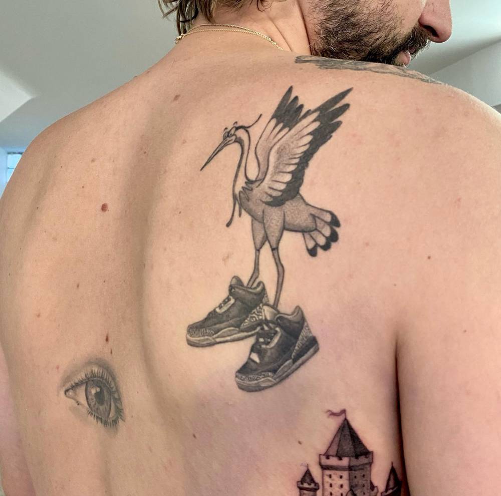 Heron showing off his or her Nike tattooed on the shoulder blade.