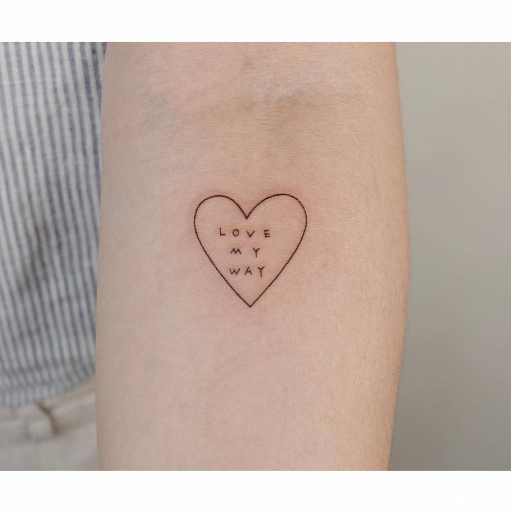 "Love my way" heart and banner tattoo located on the inner forearm.