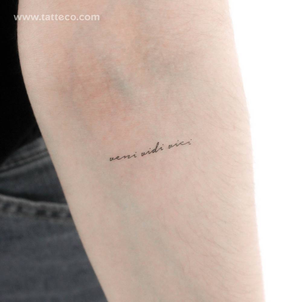 "Veni Vidi Vici" temporary lettering tattoo located on the inner forearm.