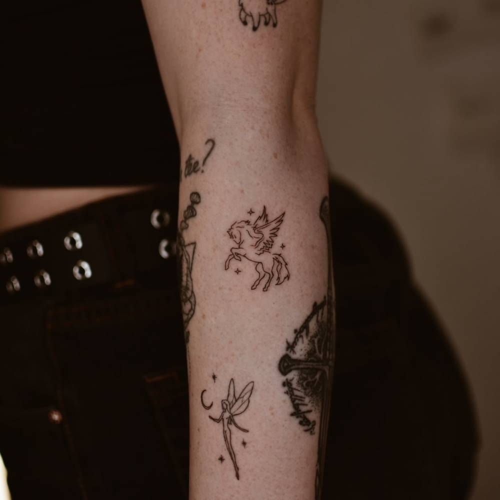 Tiny Pegasus gap filler tattoo located on the forearm.