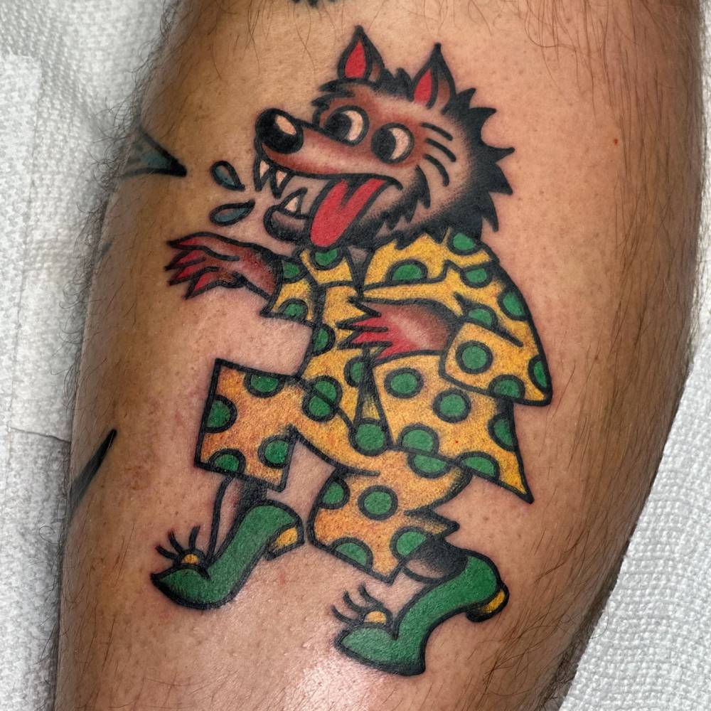 Traditional style wolf tattoo located on the inner forearm.
