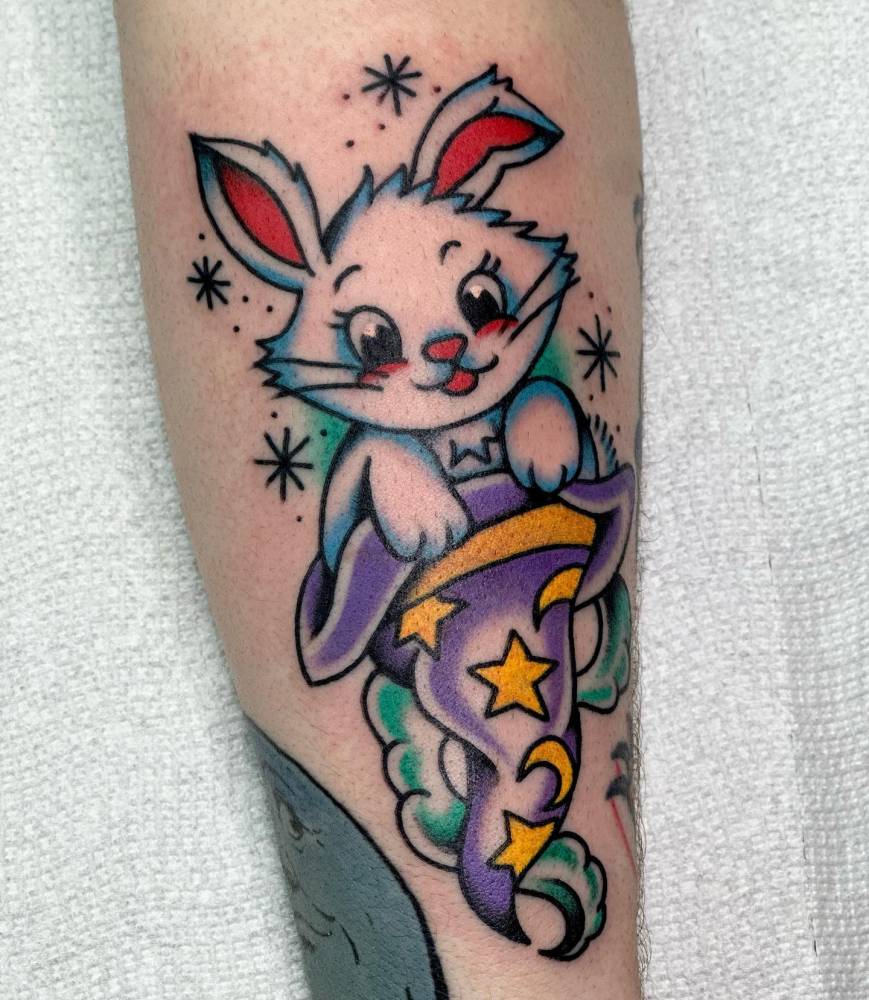 Magic rabbit tattoo located on the forearm, done in traditional style.