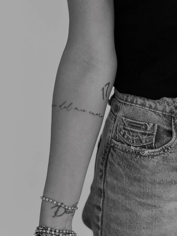 "Del mio cuore" lettering tattoo located on the inner forearm.