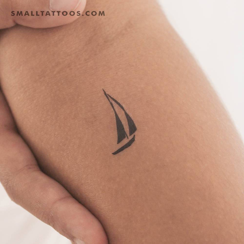 Sailboat temporary tattoo in minimalistic style placed on the inner forearm.