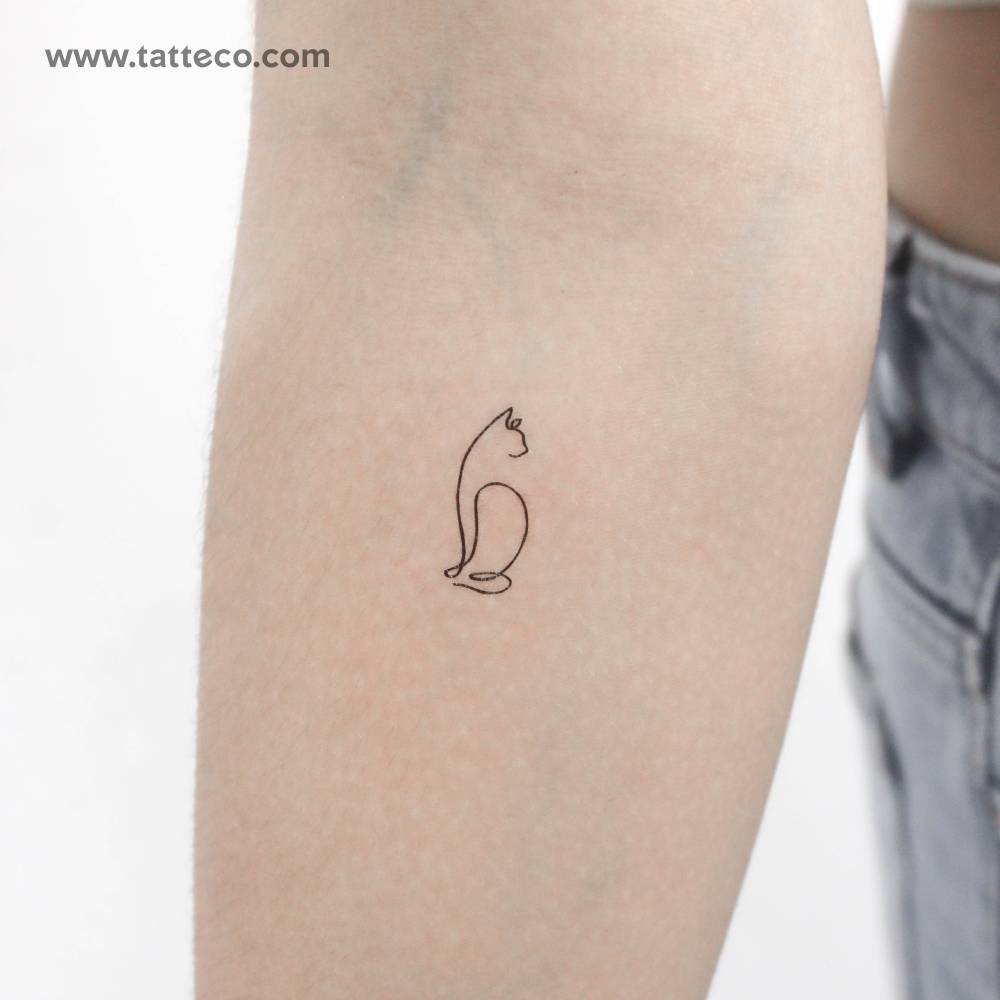 One line cat temporary tattoo located on the inner forearm.