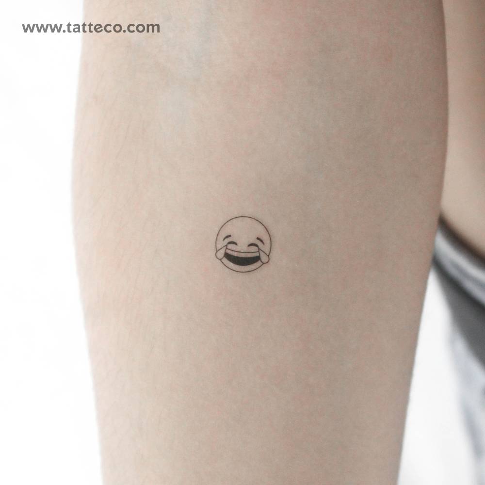 Tears of joy Emoji temporary tattoo located on the inner forearm.