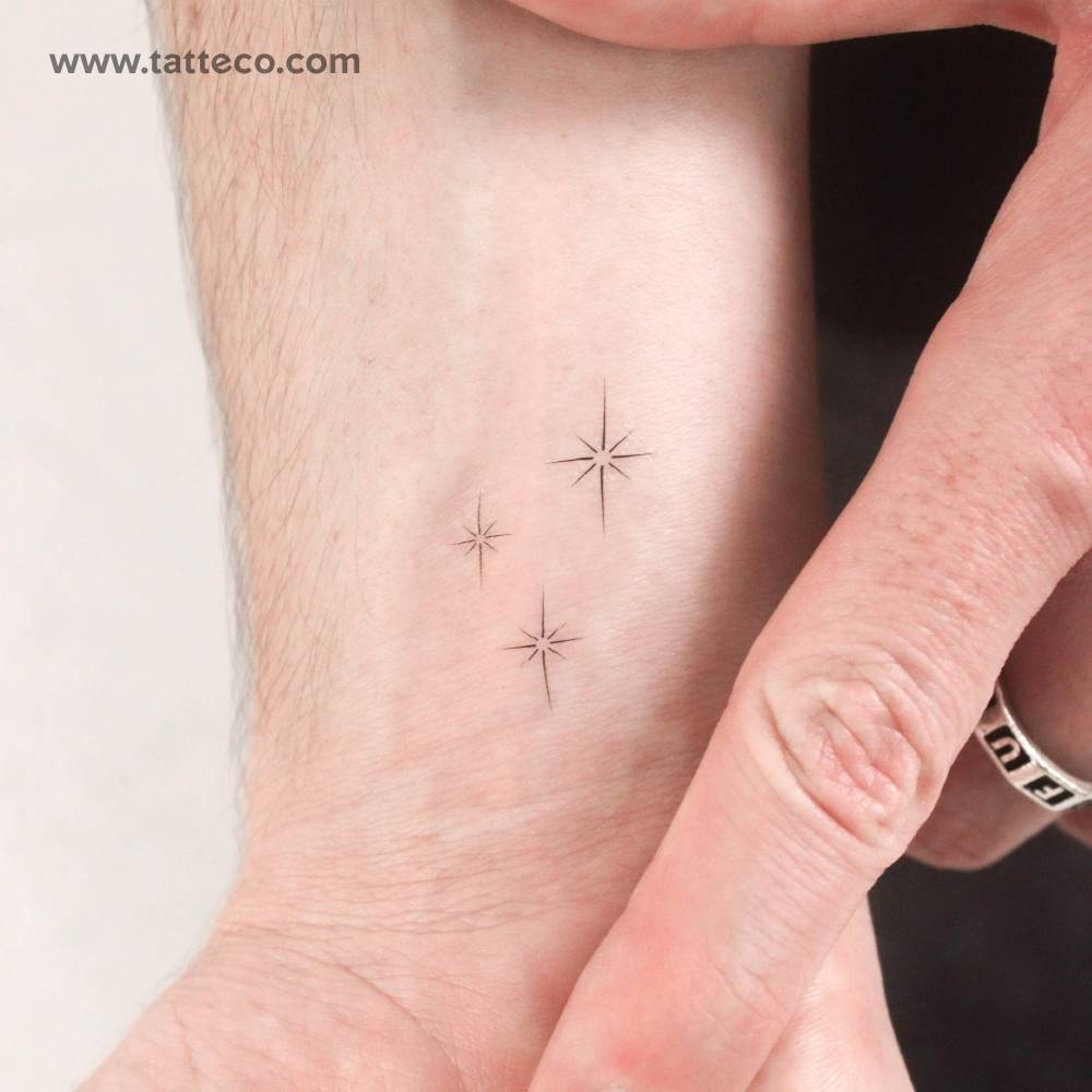 Fine line style stardust/sparkle temporary tattoo placed on the wrist.