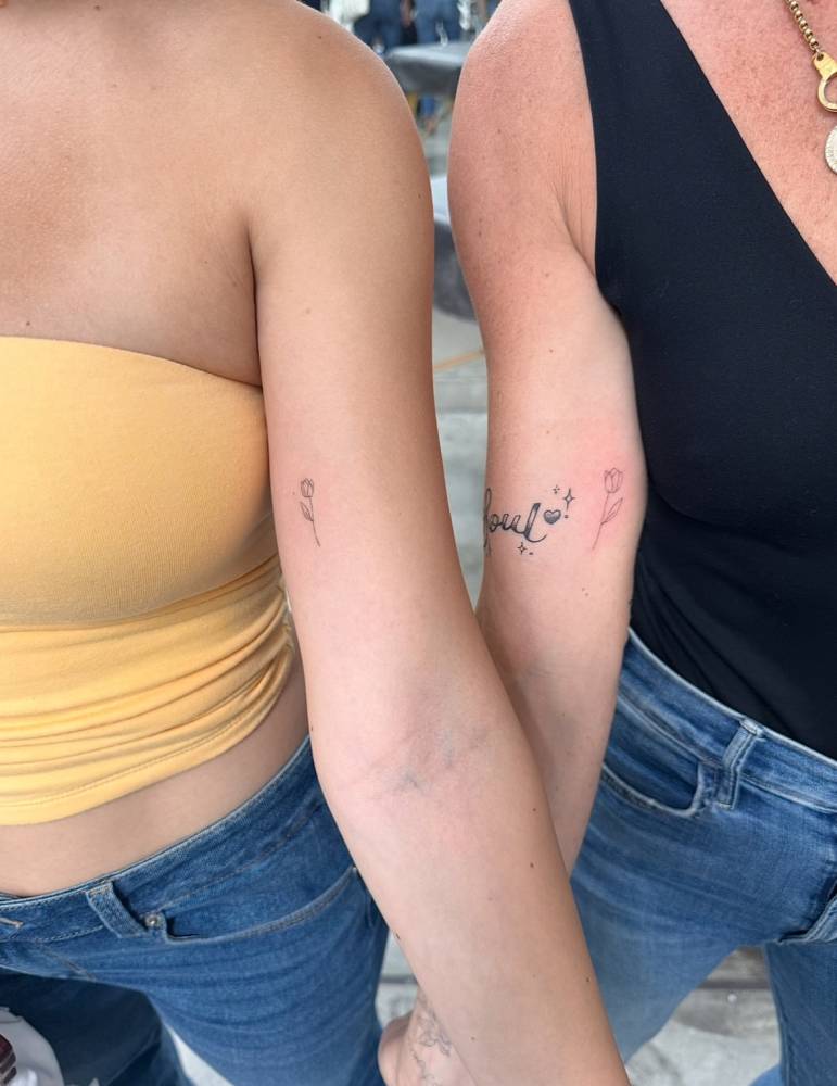 Matching fine line tulip tattoo for best friends.
