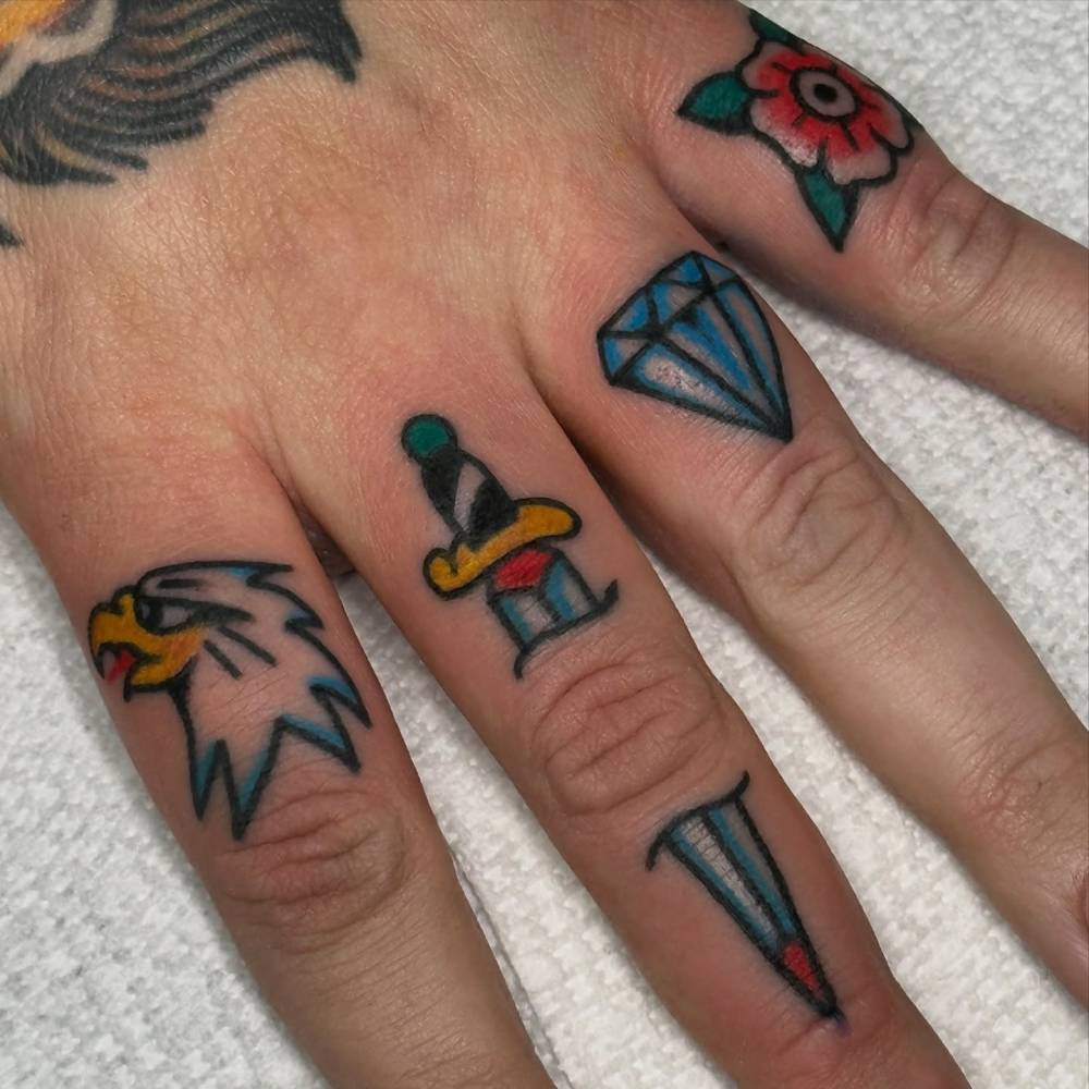 Traditional style knuckle tattoos.