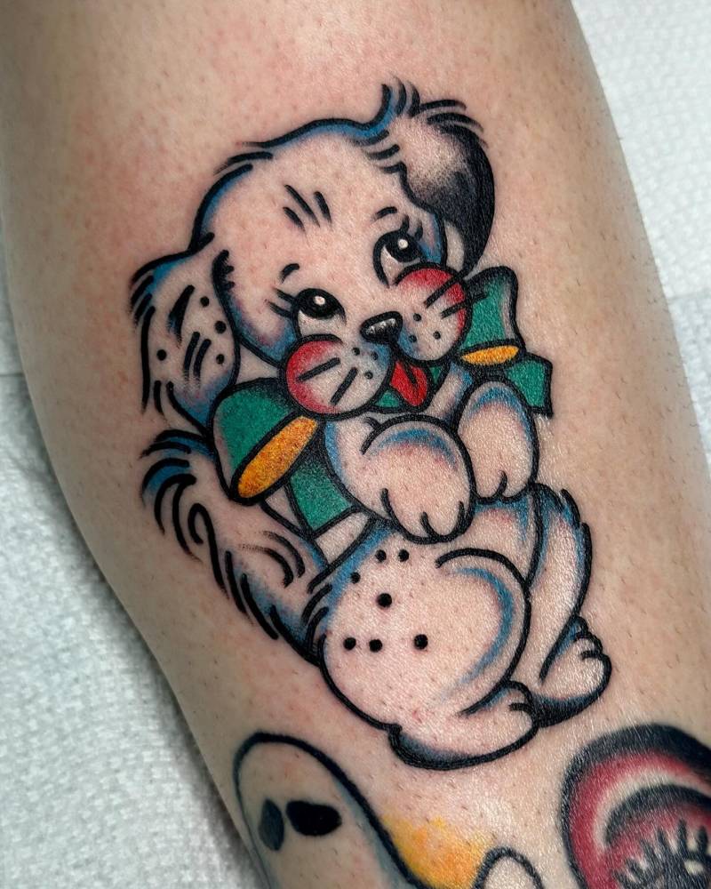 Cute dog tattoo in traditional style located on the shin.