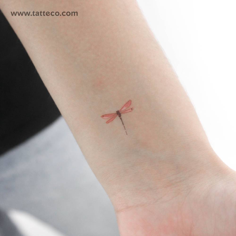 Red watercolor dragonfly temporary tattoo located on the wrist.