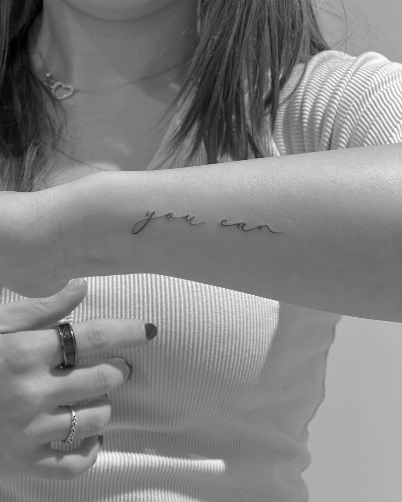 "You can" lettering tattoo located on the wrist.