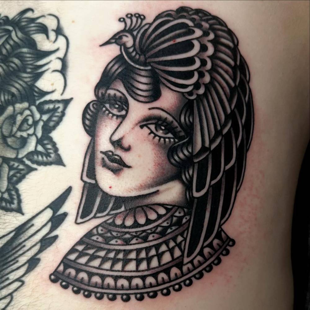 Traditional style woman portrait tattooed on the rib.