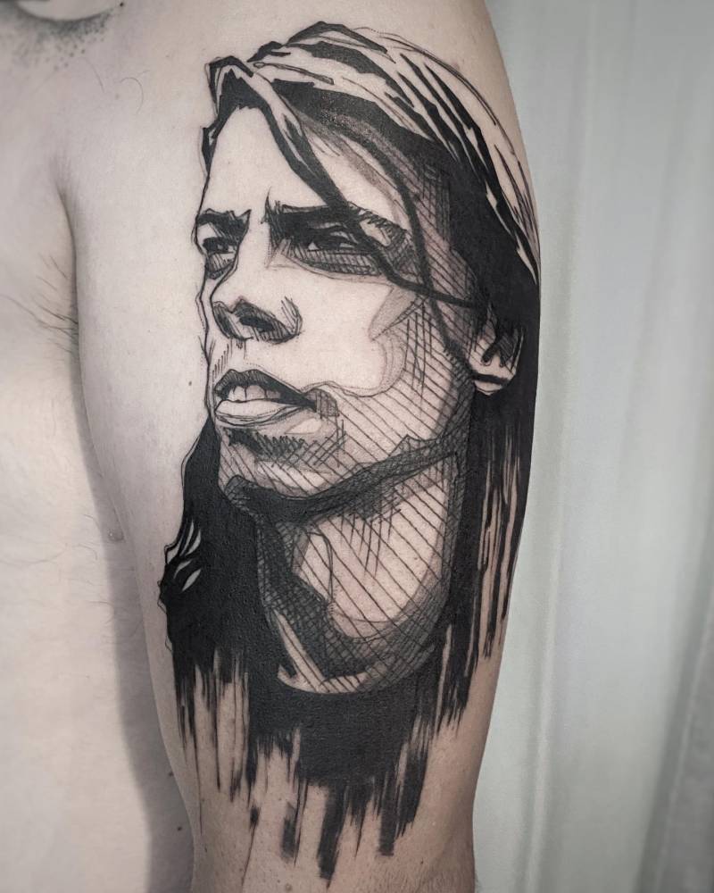 Sketch work style Dave Grohl portrait tattoo located on the upper arm.