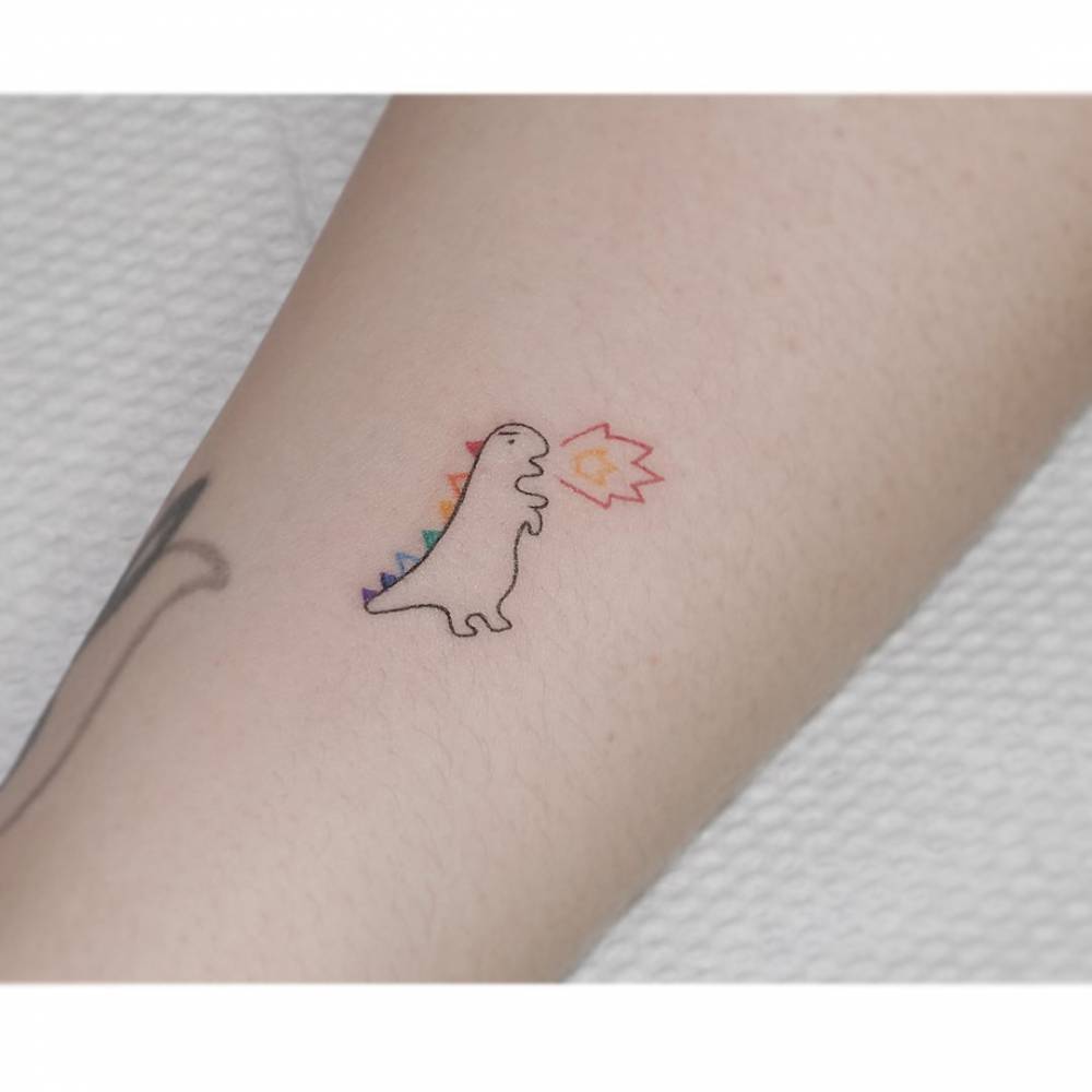 Minimalistic style dragon tattoo located on the inner forearm.