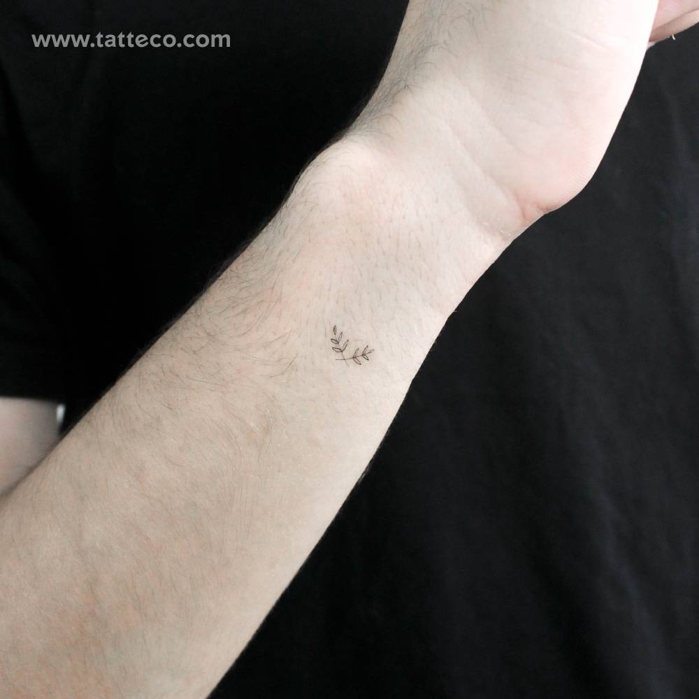 Small minimalistic wreath temporary tattoo done on the wrist.
