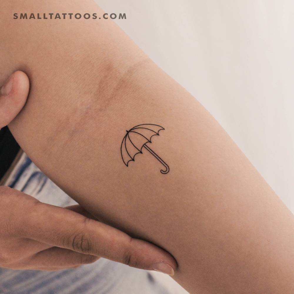 Fine line style umbrella temporary tattoo located on the inner forearm.