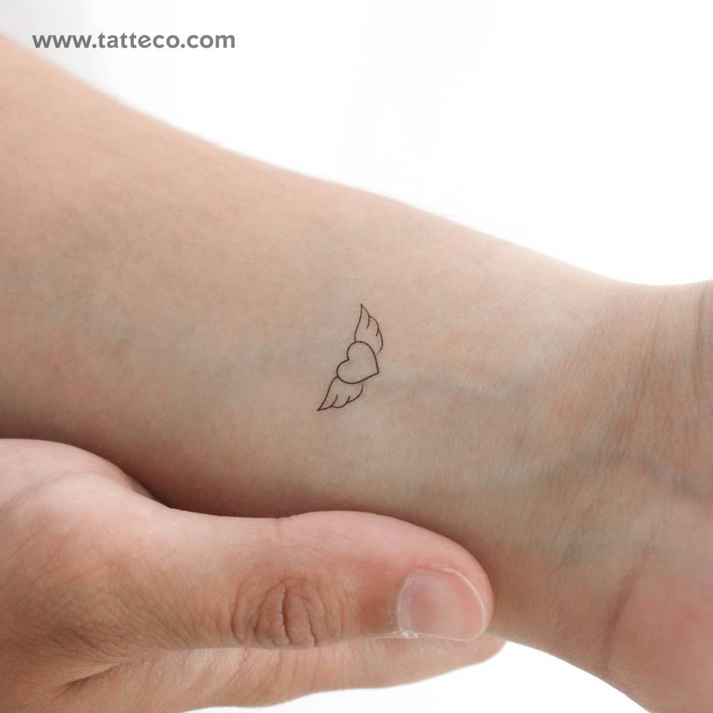 Winged heart temporary tattoo located on the wrist.