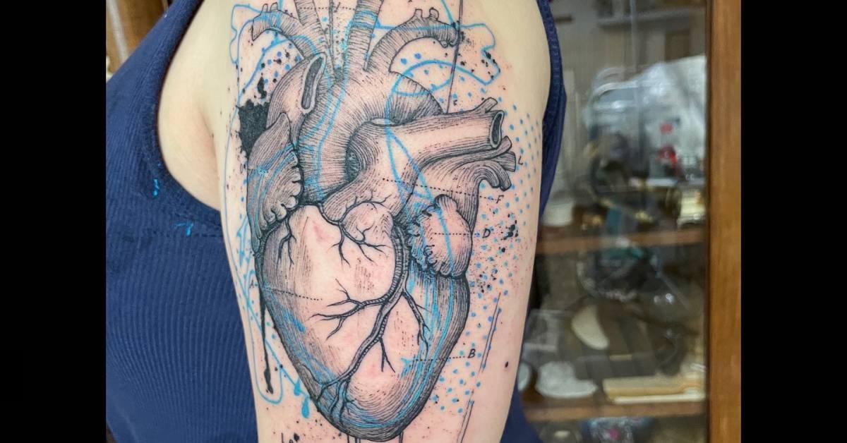 Anatomical heart tattoo located on the upper arm, done