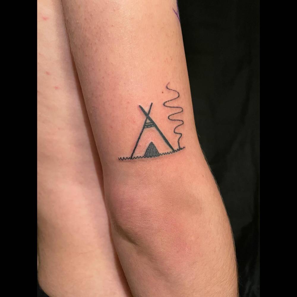 Little tipi tattoo located on the tricep, done in blackwork style.