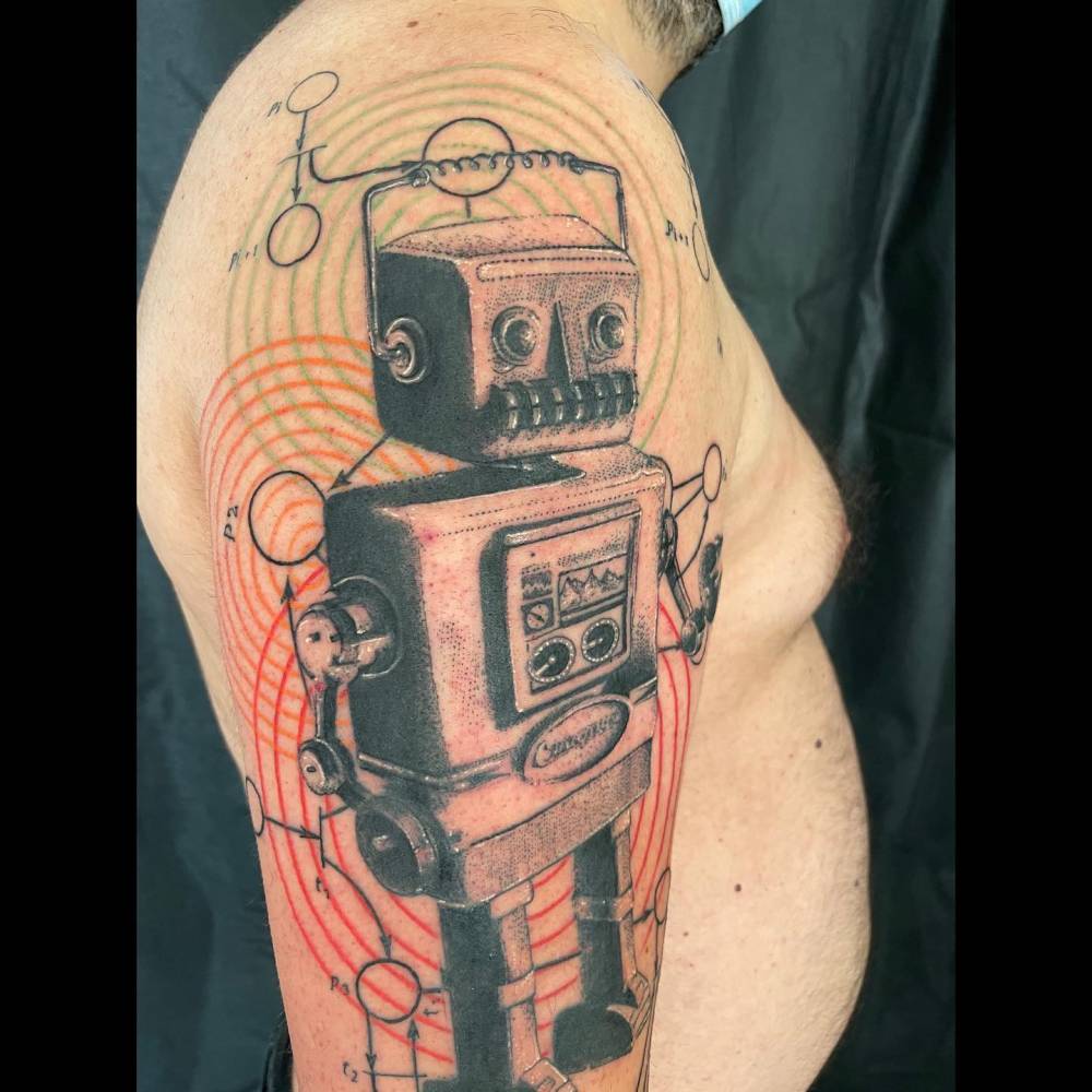 Graphic style robot tattoo located on the upper arm.