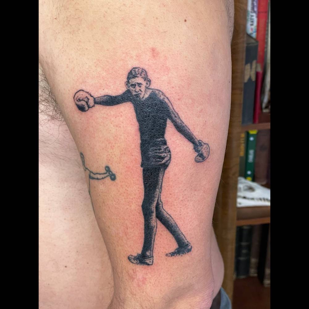 Boxer tattoo in illustrative style placed on the upper arm.