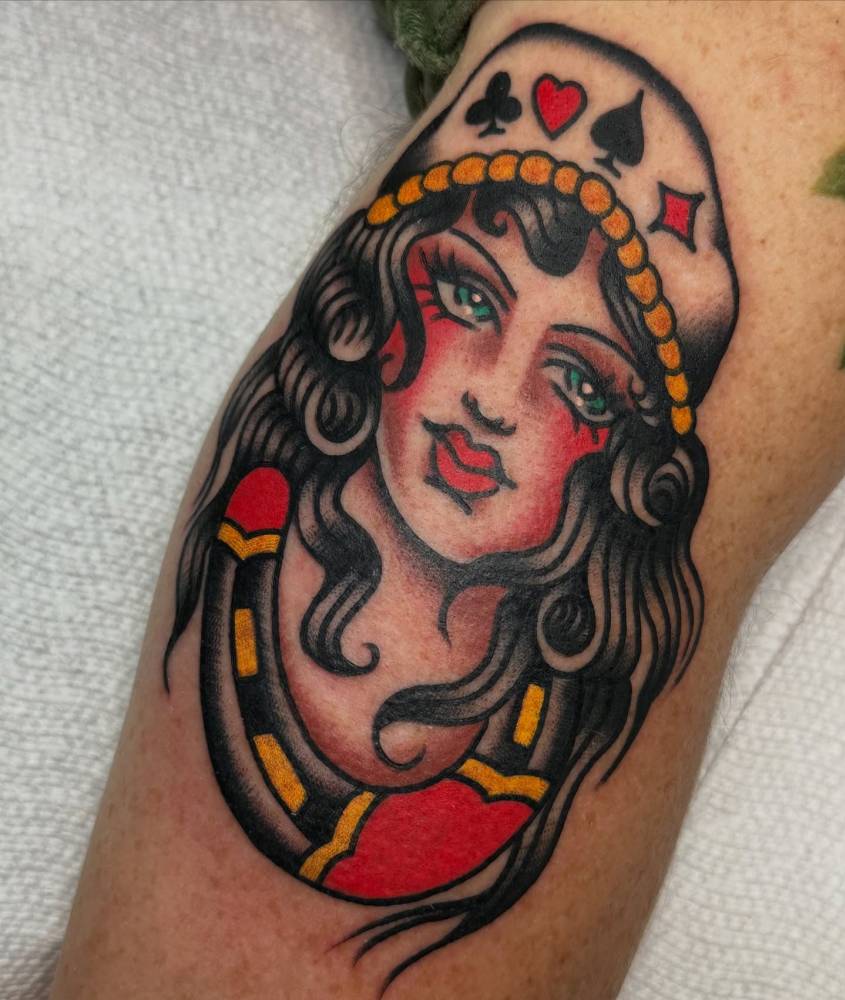 Woman portrait tattoo in traditional style placed on the elbow.