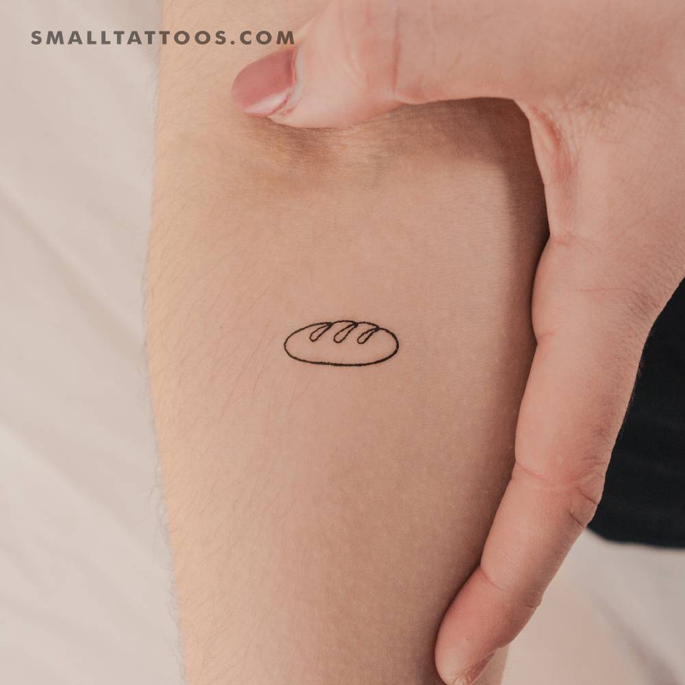 Little baguette temporary tattoo in minimalistic style placed on the inner forearm.