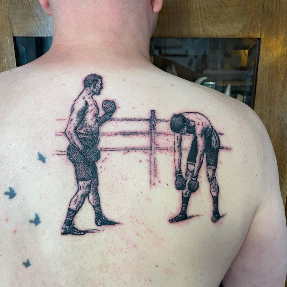 Boxers tattoo in engraving style located on the shoulder blade.
