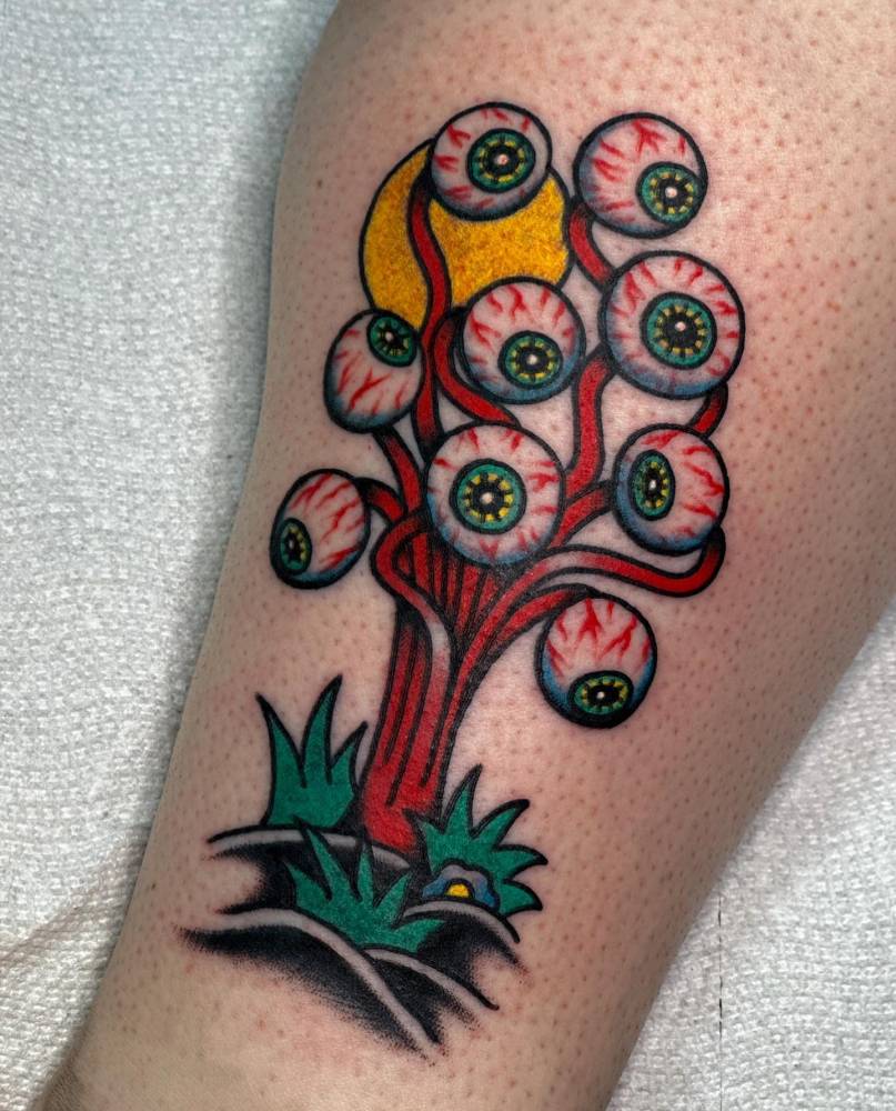 Eyes tattoo in traditional style located on the shin.