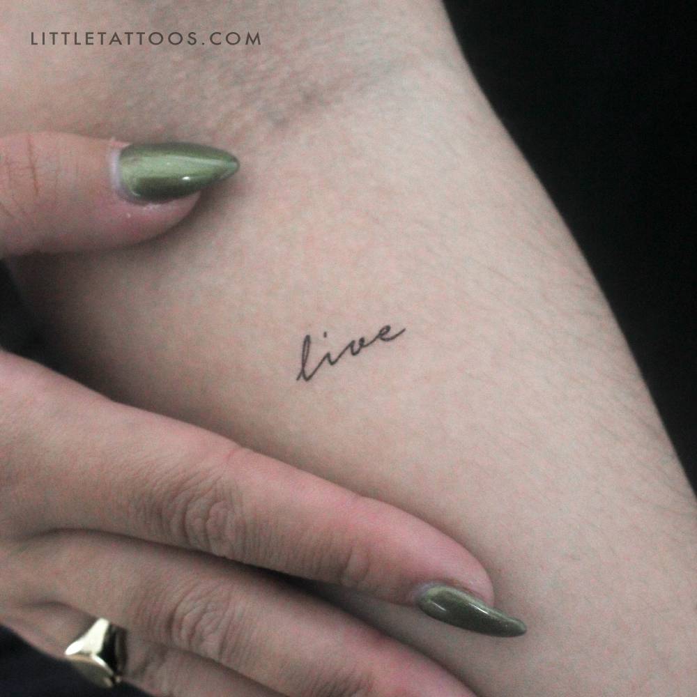 Tine word "live" temporary tattoo placed on the inner forearm.