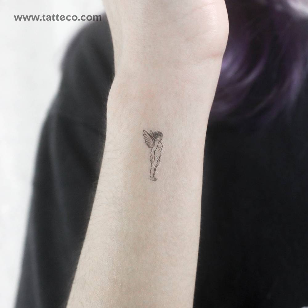 Tiny angel temporary tattoo located on the wrist.