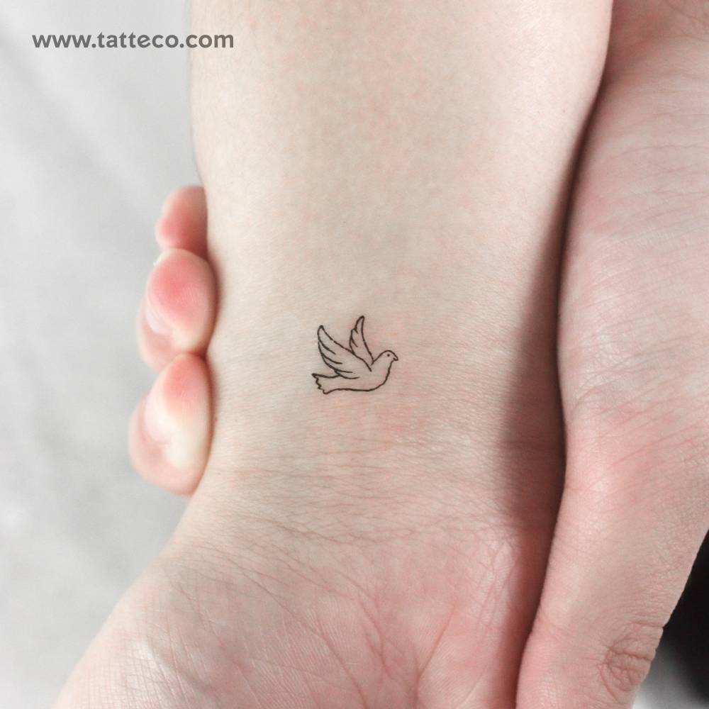 Tiny minimalistic dove temporary tattoo located on the wrist.