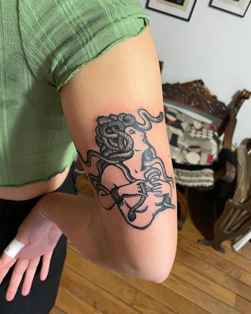 Blackwork style Medusa tattoo located on the tricep.