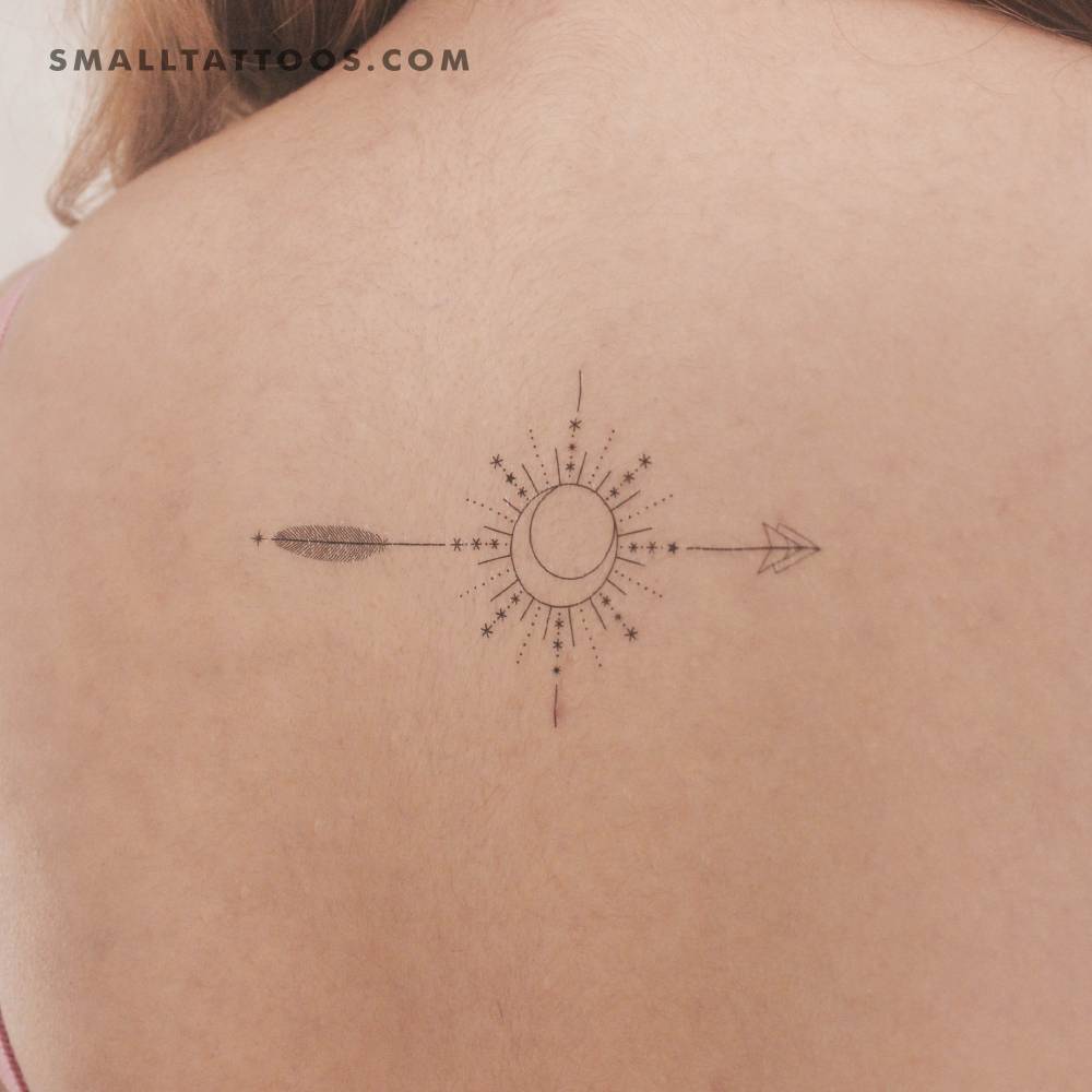 Arrow compass temporary tattoo located on the upper back.