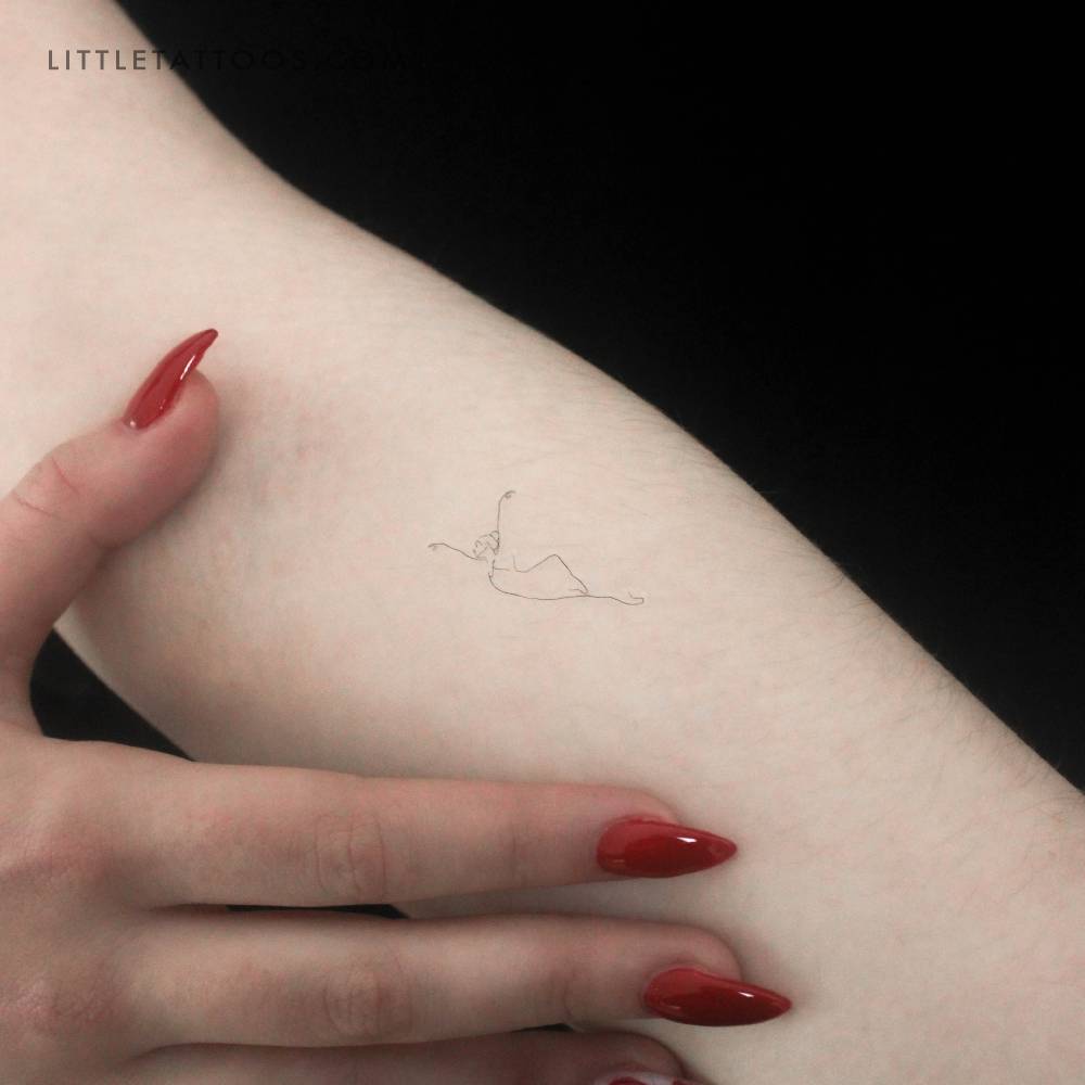 Fine line ballerina temporary tattoo located on the inner forearm.