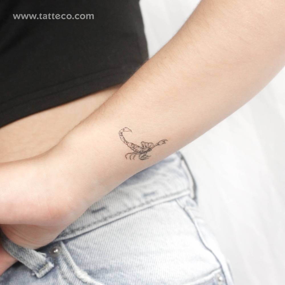 Fine line style scorpion temporary tattoo located on the wrist.
