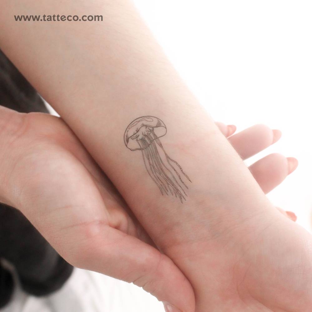 Fine line style jellyfish temporary tattoo located on the wrist.