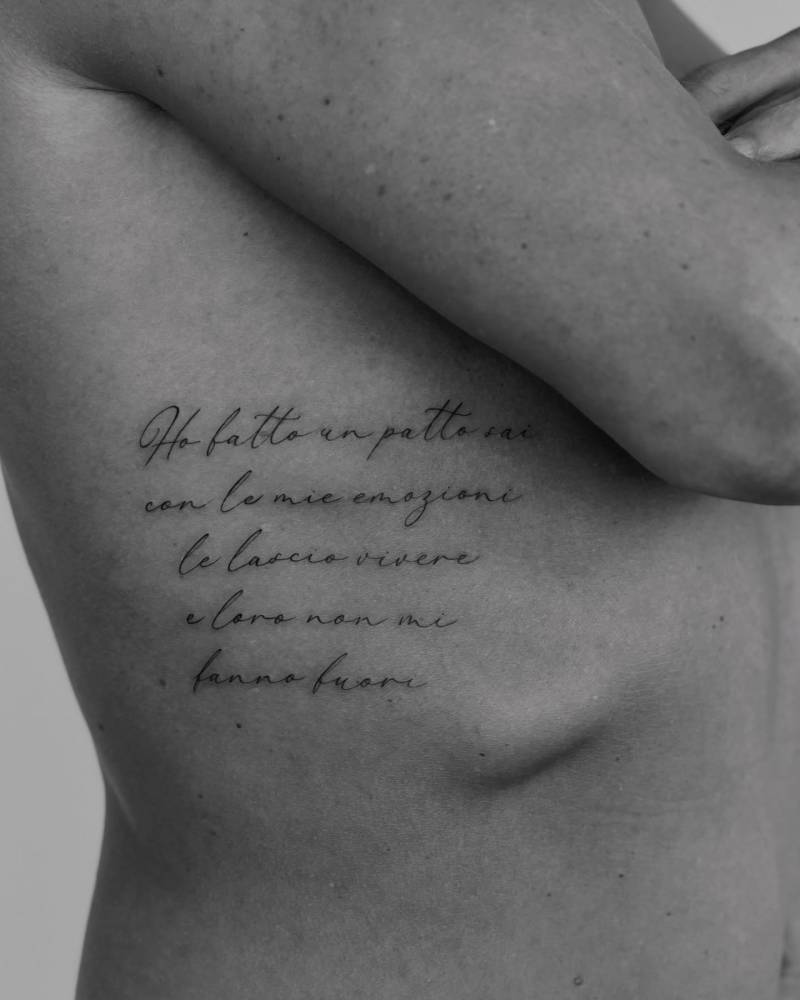 Italian quote tattoo located on the rib.