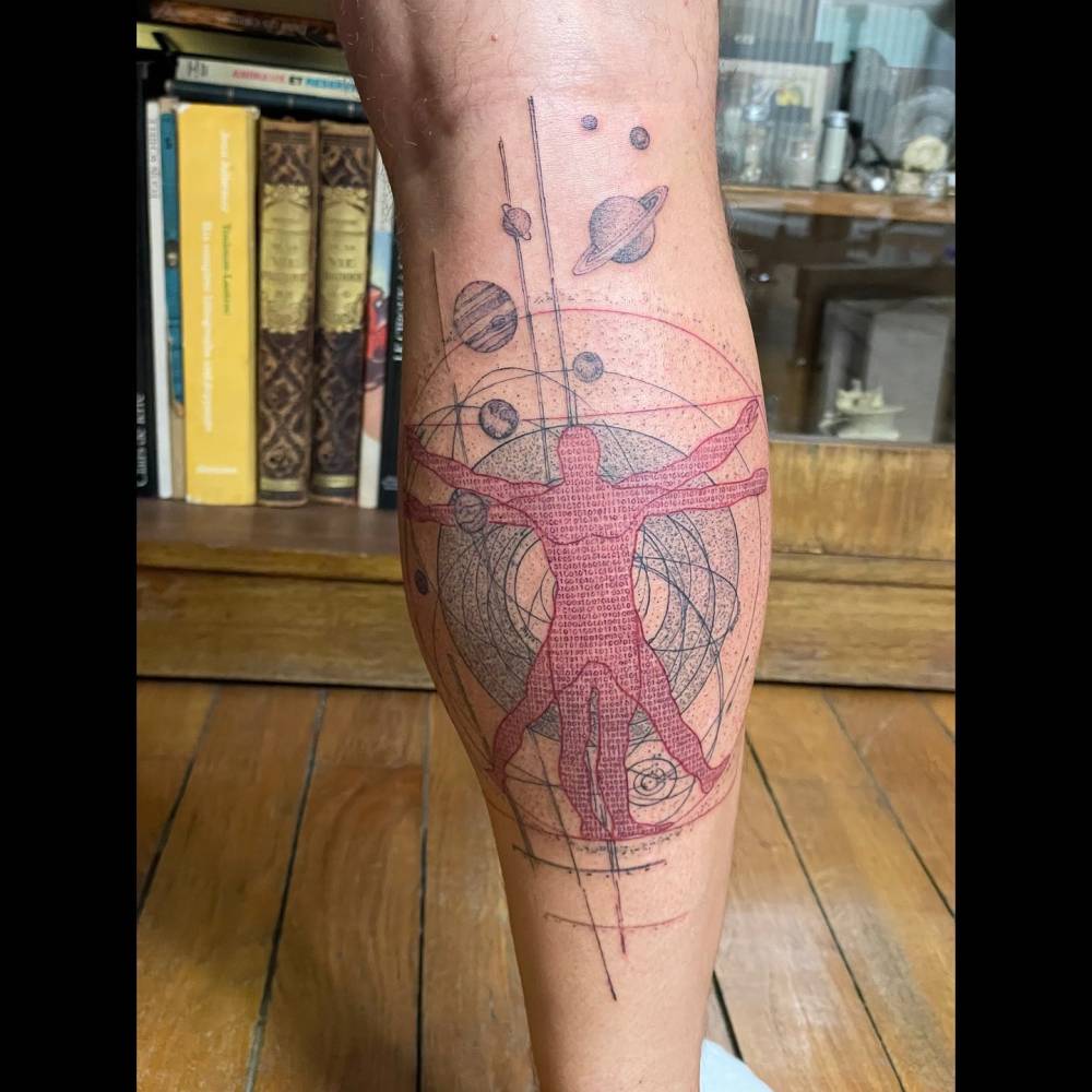 Graphic style Vitruvian Man tattoo located on the calf.