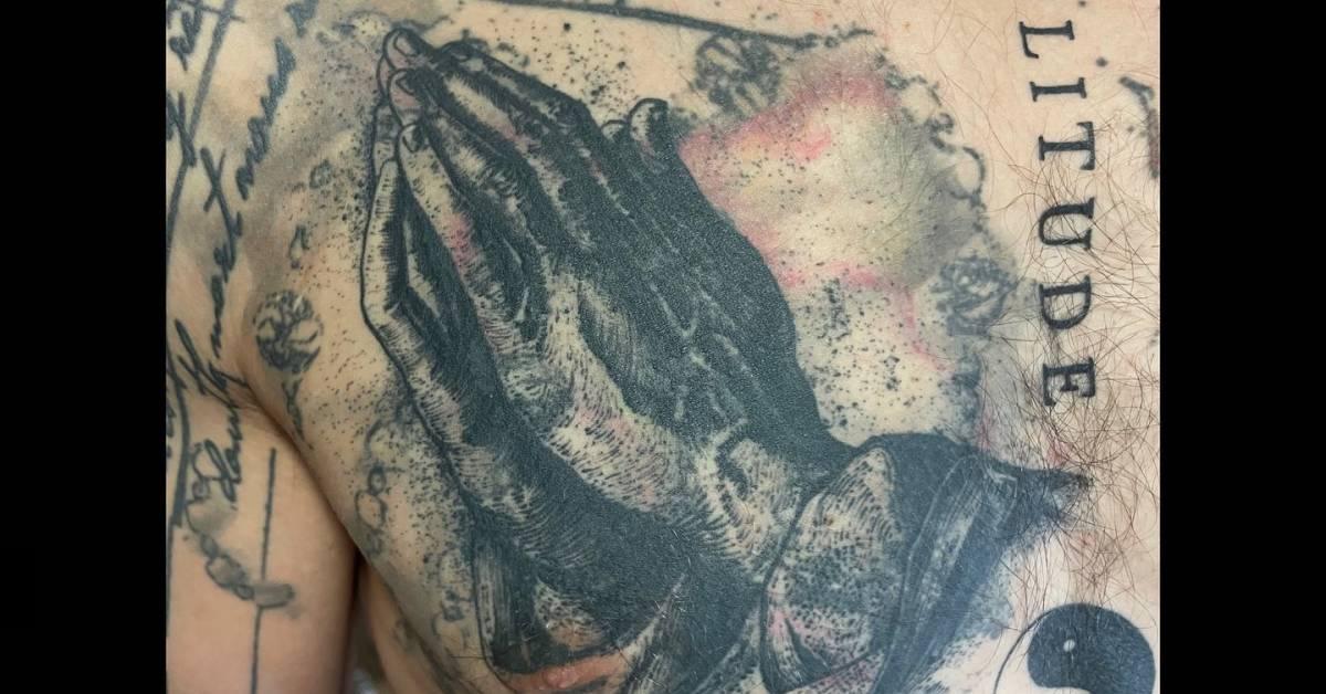 Praying Hands' tattoo in watercolor style placed on