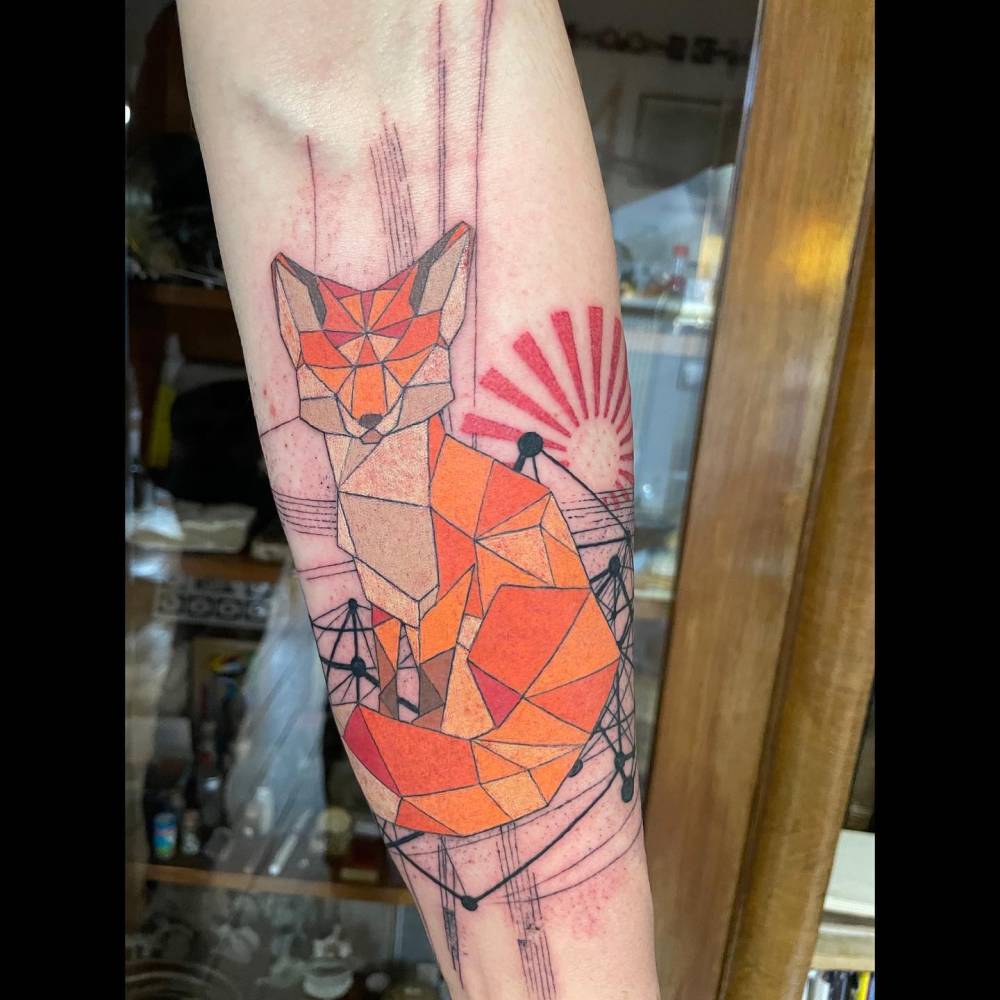 Graphic style low poly fox tattoo located on the inner forearm.