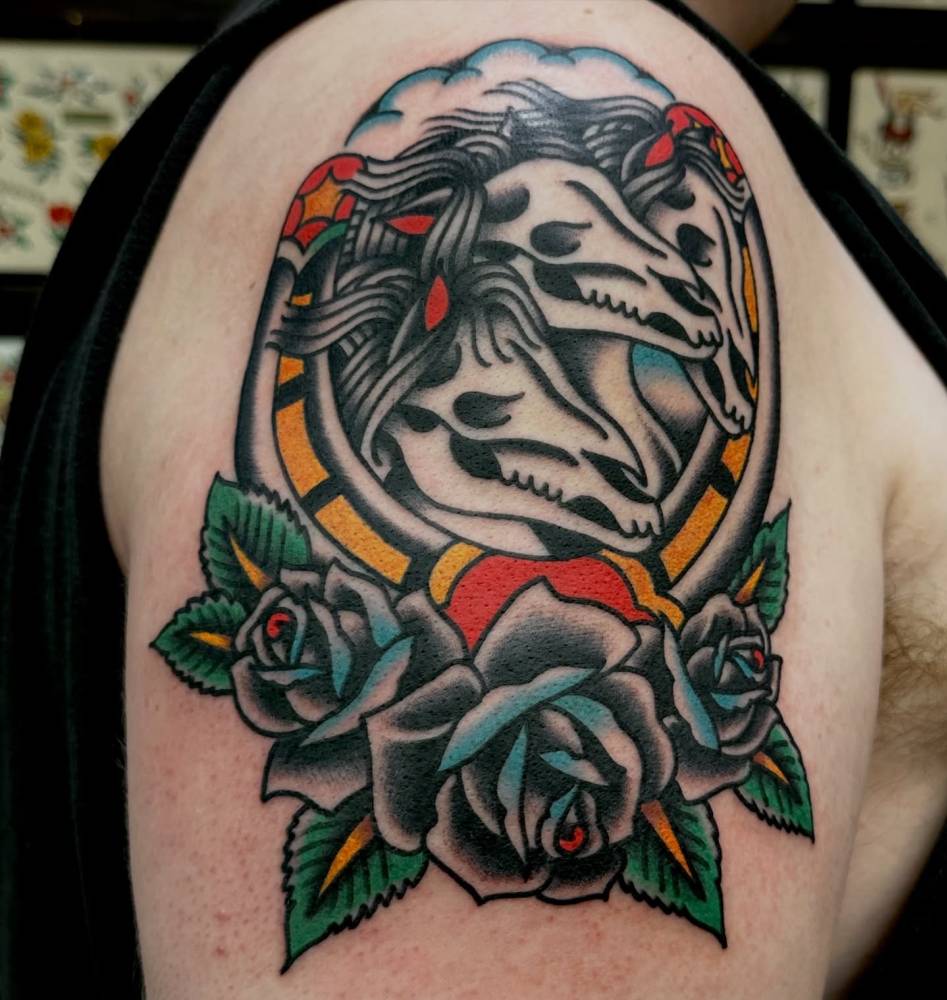 'Pharaoh's Horses' tattoo in traditional style, done on the upper arm.