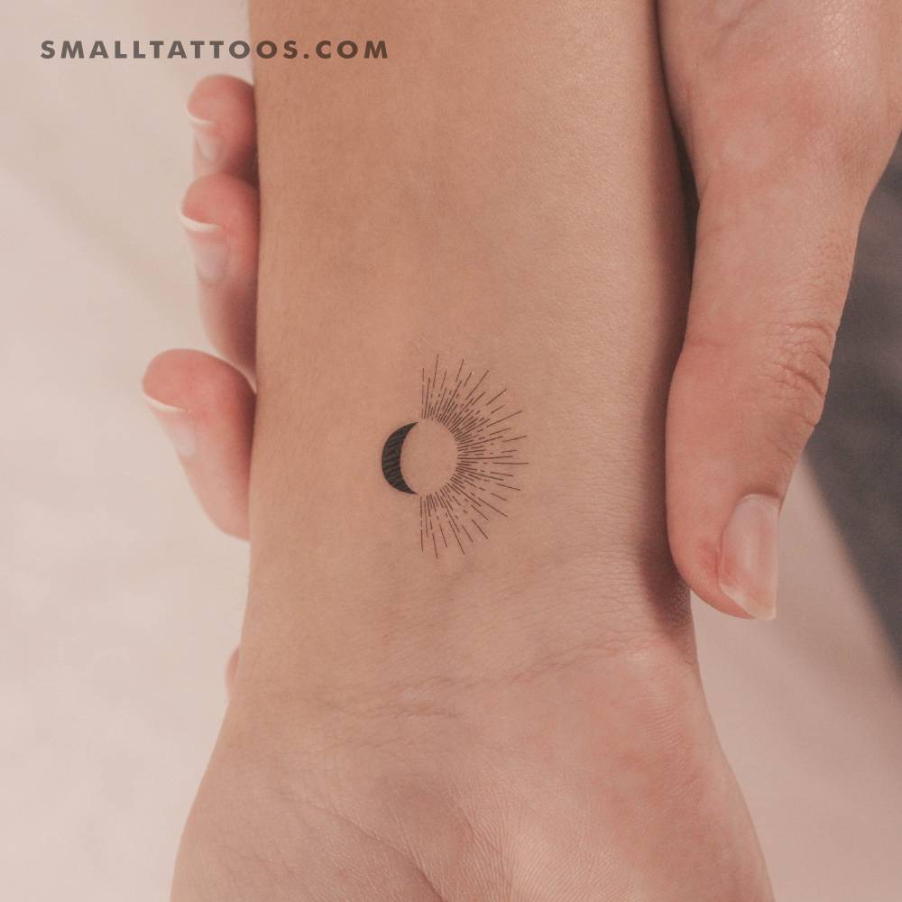 Sun and moon temporary tattoo located on the wrist.