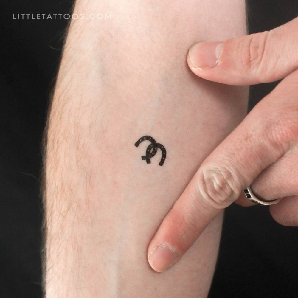 Minimalistic style horseshoe couple temporary tattoo done on the inner forearm.