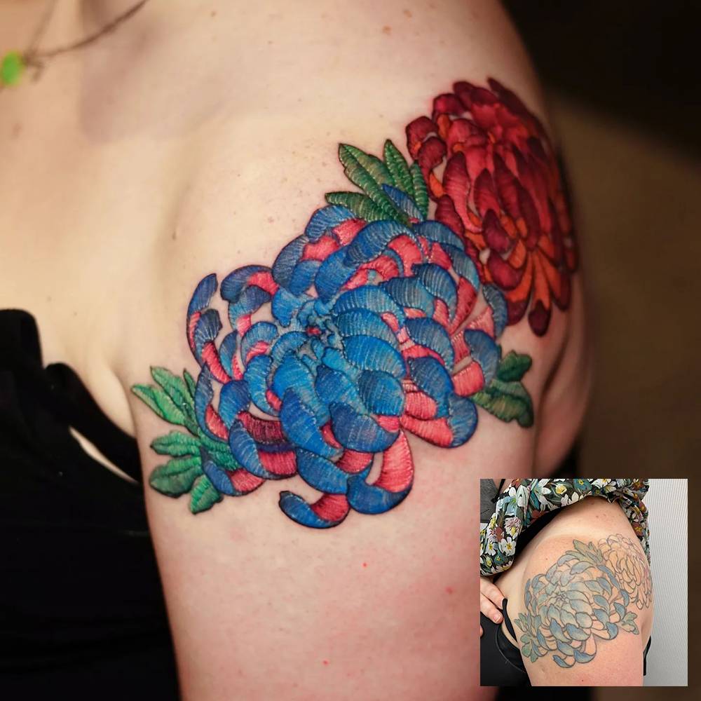 Embroidery style chrysanthemums cover up tattoo located on the shoulder.